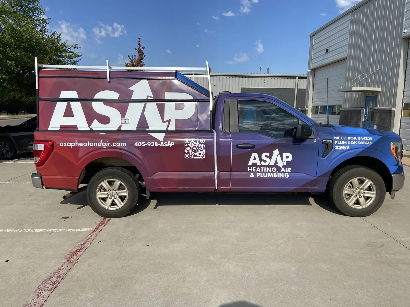 Driver side of the ASAP Ford F-150 wrap showing the logo, phone number, website, QR code, and license numbers